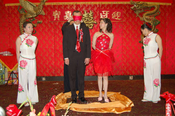 Pres. Gong
                    with jacket on, along girl tied up, curtain goes up